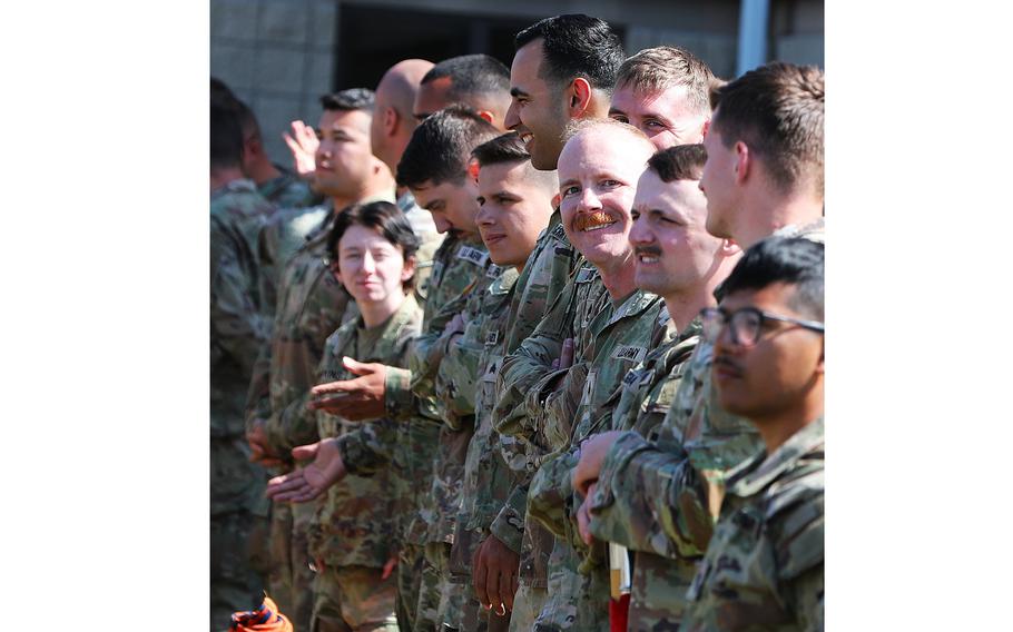 A soldier smiles in formation