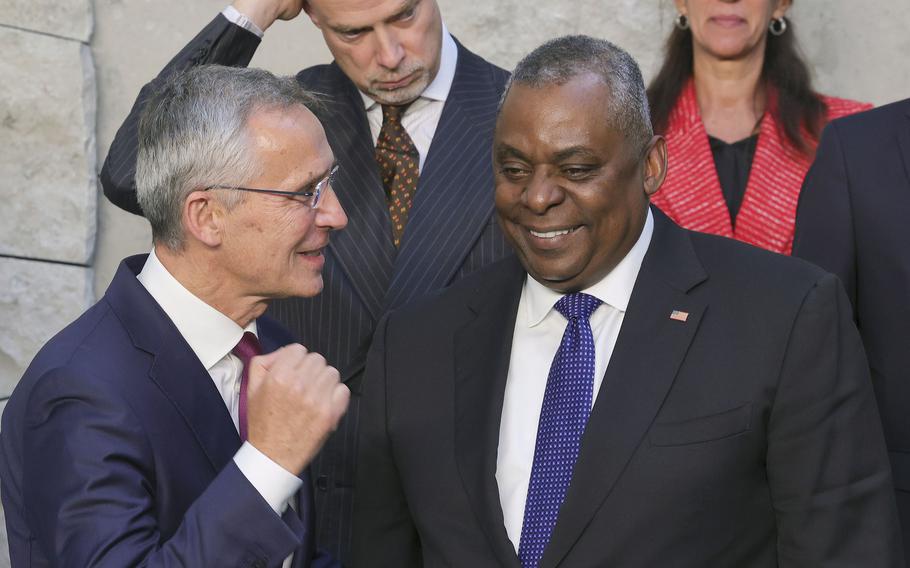 NATO Secretary General Jens Stoltenberg, left, speaks with U.S. Secretary for Defense Lloyd J. Austin III during a group photo of NATO defense ministers at NATO headquarters in Brussels, Thursday, Oct. 13, 2022.  