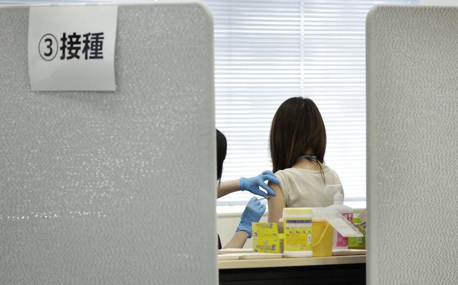 A Suntory Holdings employee receives a dose of the Moderna COVID-19 vaccine at the company's office in Tokyo , on June 21, 2021. 