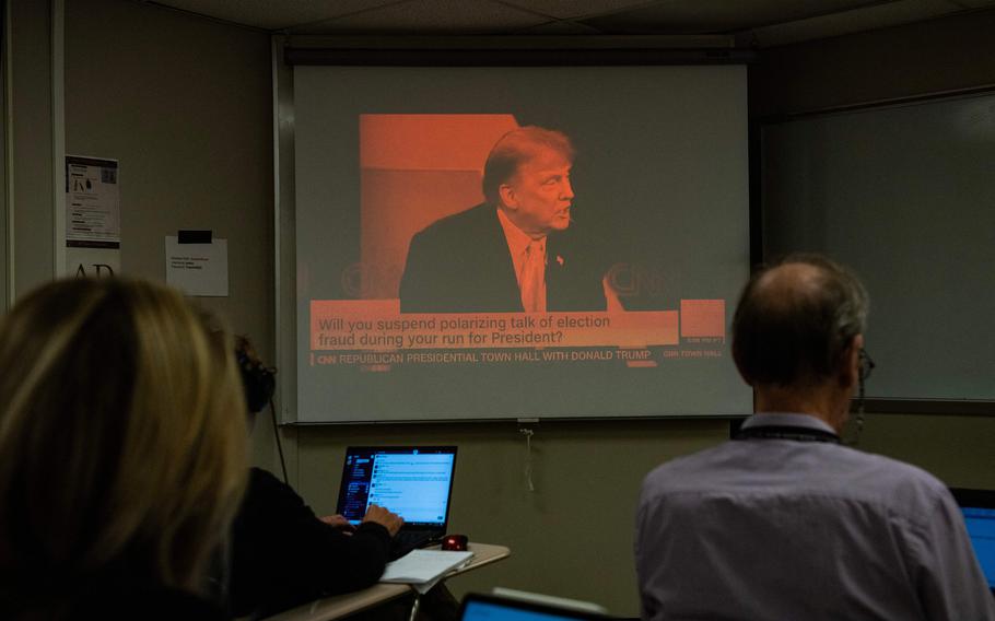 Reporters watch a CNN town hall with former  President and 2024 Presidential hopeful Donald Trump at St. Anselm College in Manchester, N.H., on May 10, 2023. 