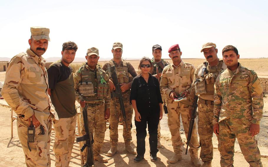 Zainab Olivo poses with Iraqi troops while working as an interpreter and translator for Stars and Stripes during the Battle of Mosul in 2017.