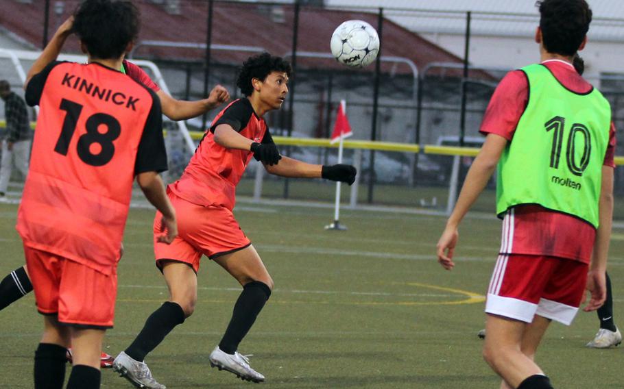 Nile C. Kinnick's Gabriel Robinson heads the ball against St. Maur International during Tuesday's Japan boys soccer match. The Red Devils blanked the Cougars 2-0.