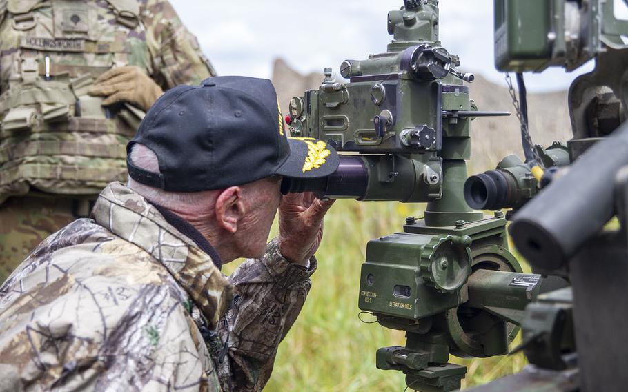 Hilton Labow, a 98 year-old WWII Veteran, looks down the sight on a M119 A2 Howitzer on August 10, 2022. Mr. Labow Visited Fort Drum and watched a live fire exercise conducted by 2nd Battalion, 15th Field Artillery Regiment, 2nd Brigade Combat Team, 10th mountain Division.