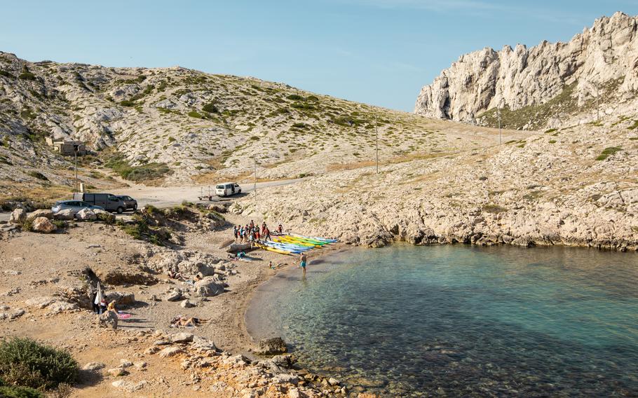 Visitors settle in for the day in the National Park of Calanques, France. 