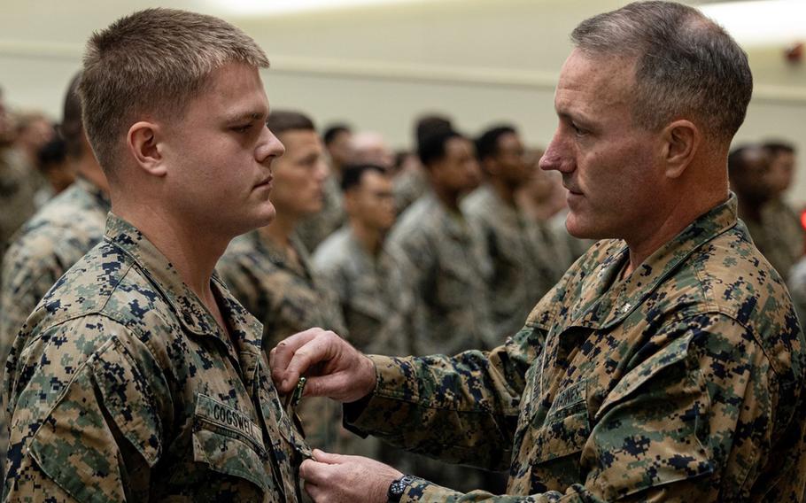 Cpl. Jacob Cogswell receives a Navy and Marine Corps Commendation Medal from Lt. Col. Andrew Nicholson at Camp Schwab, Okinawa, on Jan. 12, 2024.