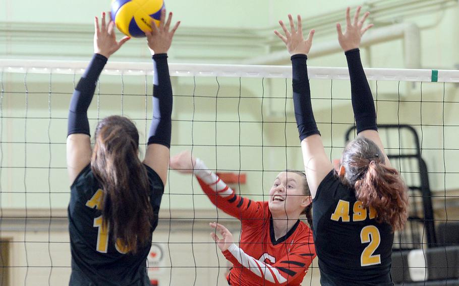 E.J. King's Madylyn O'Neill spikes between American School In Japan's Lily Stone-Bourgeois and Mari Annis during Thursday's pool-play match in the Ryukyu Island Tournament. The Cobras won in straight sets.