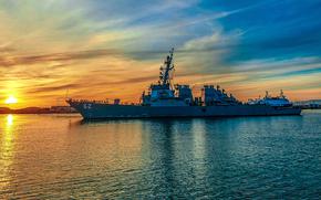 A Navy destroyer seen with a vibrant yellow and blue coloring the sea and sky around it.