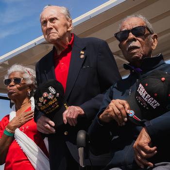 Robert Bouley, left, and Daniel Keel, World War II veterans, hold their caps during the national anthem at MacDill Air Force Base, Fla., Saturday, March 30, 2024. Bouley and Keel were honored for their contributions to the United States at Tampa Bay AirFest. Boule joined the U.S. Marine Corps on March 3, 1942, and served as a radar operator and heavy AA Gun crewman on the USS Texas during the invasions of North Africa, the Battle of Normandy and the invasion of Southern France. Keel served as a pilot, navigator and bombardier for the U.S. Army Air Corps from 1943 to 1946, and was one of only five Tuskegee Airmen to receive a triple airman rating.