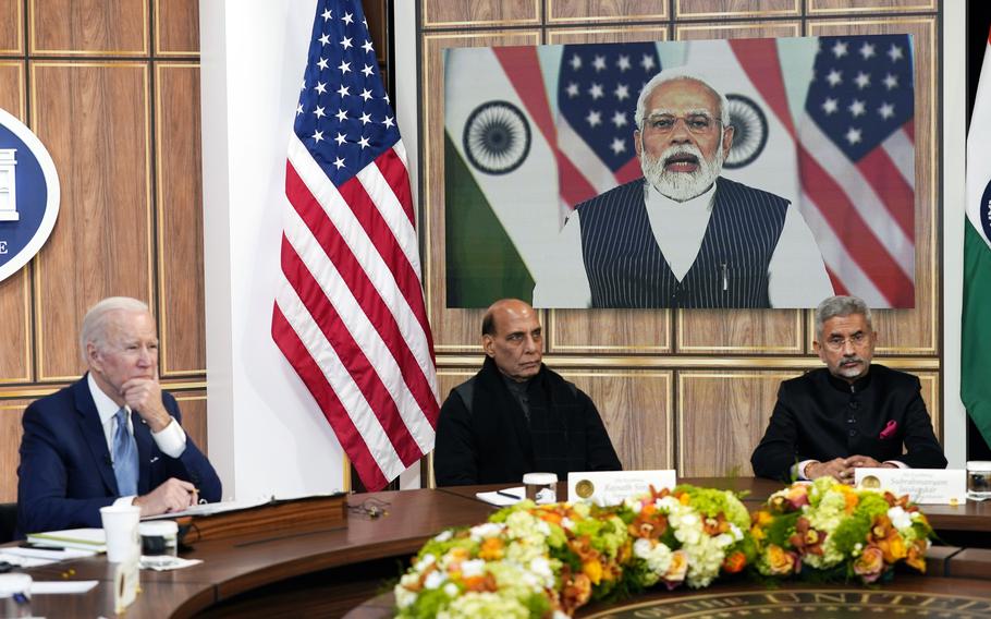President Joe Biden meets virtually with Indian Prime Minister Narendra Modi in the South Court Auditorium on the White House campus in Washington, Monday, April 11, 2022. Indian Minister of Defense Rajnath Singh is center, Minister of External Affairs Subrahmanyam Jaishankar is right. 