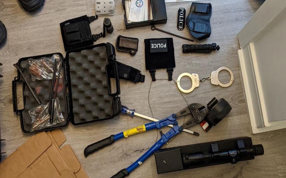Prosecutors say this photo shows items from the apartment of Arian Taherzadeh including a rifle scope, tactical gear and storage equipment, clothing and patches with police insignias, handcuffs, breaching equipment, and a cleaning kit for firearms. 