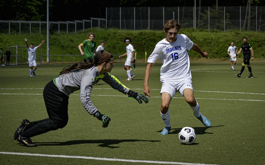 Alconbury goalkeeper Abigail Hudson leaps in front of Sigonella’s Joseph Eck to stop his goal attempt during the 2024 DODEA European Soccer Division III Championships in Landstuhl, Germany, on May 20, 2024. Eck managed to navigate past her to score.
