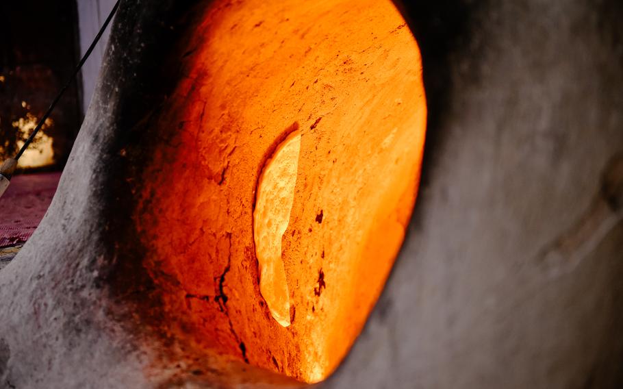 Bread bakes in a tannour oven at a Bahraini bakery near the Muharraq souk on April 28, 2024.