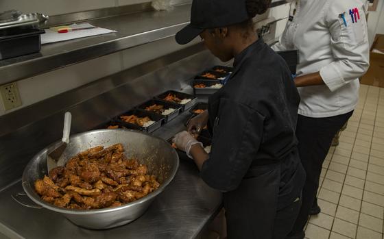 Culinary soldiers prepare meal kits to sell as a to-go option in dining kiosks at Fort Carson, Colo. The base provides grab-and-go meals at kiosks instead of traditional dining facilities on the weekends. 