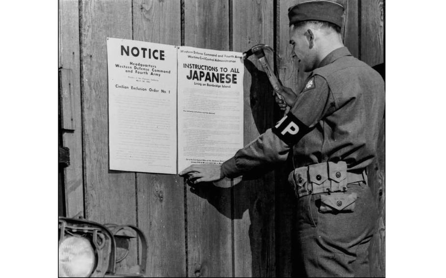 A military police officer posts Civilian Exclusion Order No. 1 on Bainbridge Island. 