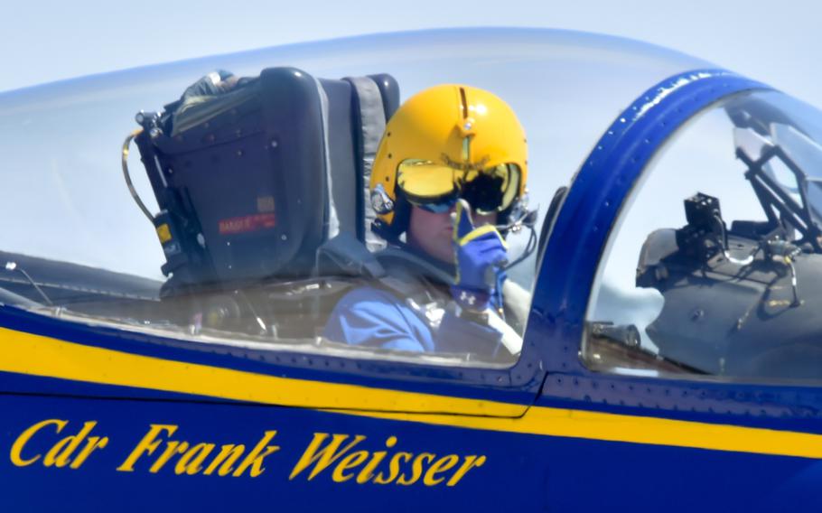
Then-Cmdr. Frank Weisser, lead solo pilot assigned to the Navy flight demonstration squadron known as the Blue Angels, points to the crowd at a Wings Over Wayne air show in North Carolina in 2017. 