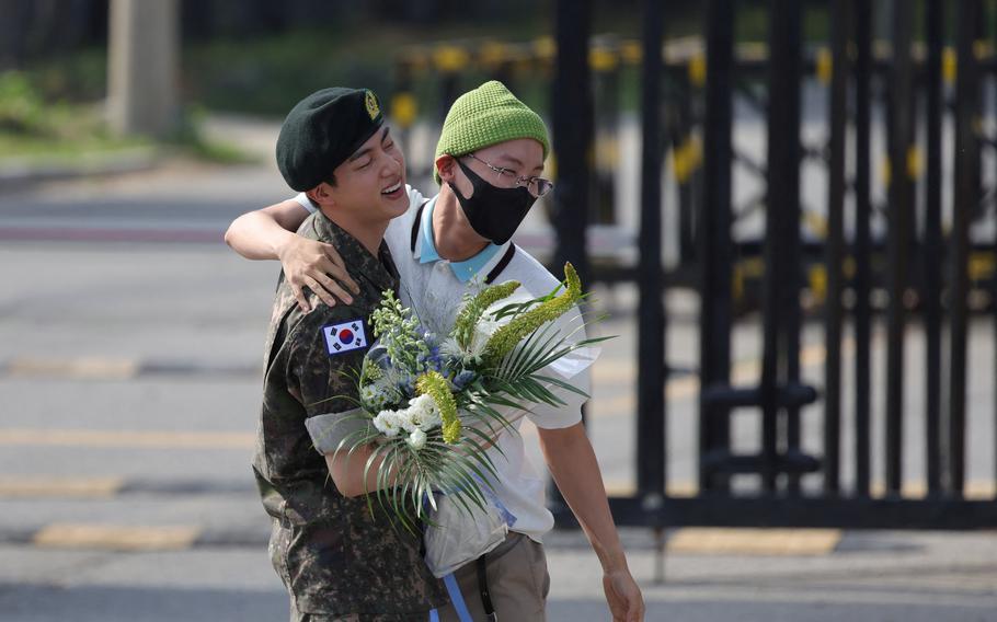 K-pop boy band BTS member Jin is greeted by group member J-Hope after being discharged from the military in Yeoncheon, South Korea, June 12, 2024.