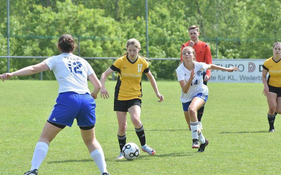 Stuttgart's Haley Wells tries to make her way between Wiesbaden defenders Hannah Buccheit, left, and Loren Venton, in the DODEA-Europe Division I girls soccer semifinals Wednesday, May 17, 2023.