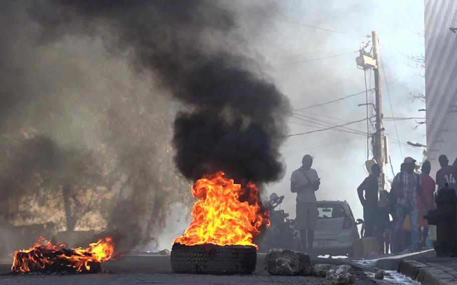 This screen grab taken from AFPTV shows tires on fire near the main prison of Port-au-Prince, Haiti, on March 3, 2024, after a breakout by several thousand inmates.