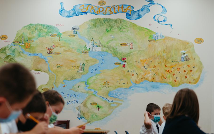 A map of Ukraine decorates a classroom. 