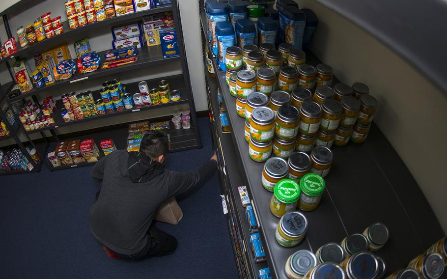 A service member chooses items from the food pantry at Yokota Air Base, Japan, during a government shutdown, Jan. 24, 2019.