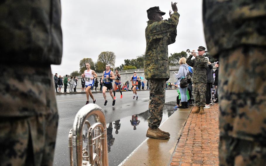 Runners in the 2019 Marine Corps Marathon pass the United States Marine Band at mile 10, at the foot of the Lincoln Memorial in Washington, D.C. 