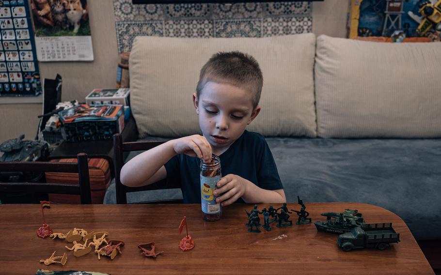 Oksana Leontieva's son Hrysha, 5, plays with toy soldiers at home in Kyiv, Ukraine. 