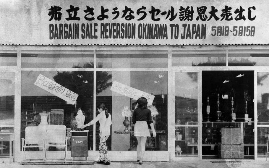 A sign above a furniture store in Naha, Okinawa, announces, "Bargain Sale Reversion Okinawa to Japan," May 13, 1972.