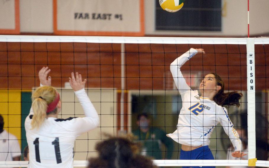 Yokota's Elena Haas readies a spike against Zama American's Kaitlin McAbee during Saturday's Japan girls volleyball match. The Panthers won in four sets.