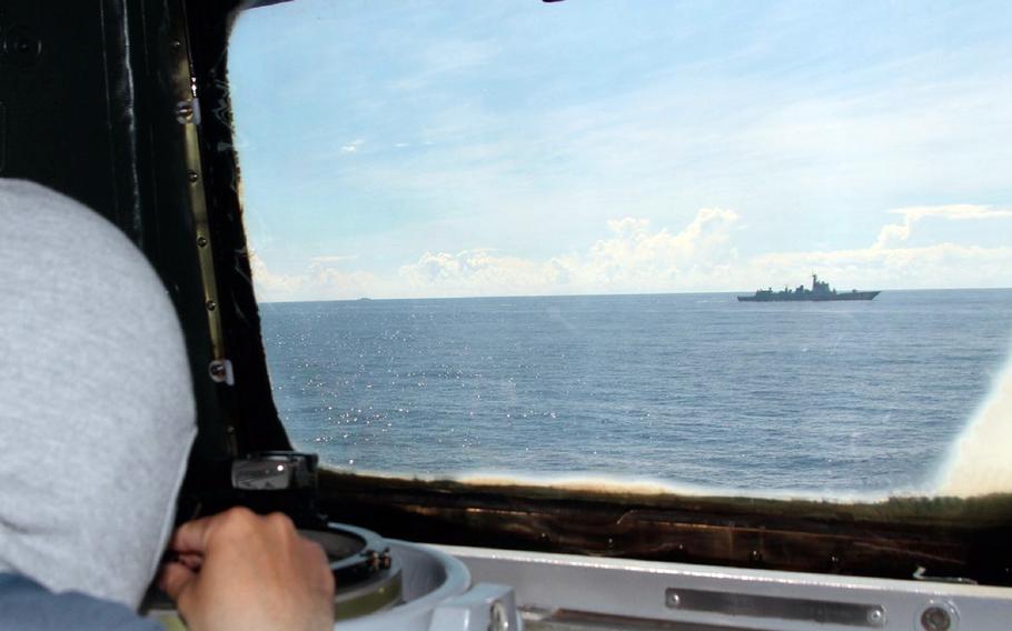 A member of the Taiwan navy keeps tabs on a Chinese vessel during an exercise surrounding the island on Saturday, Aug. 6, 2022.