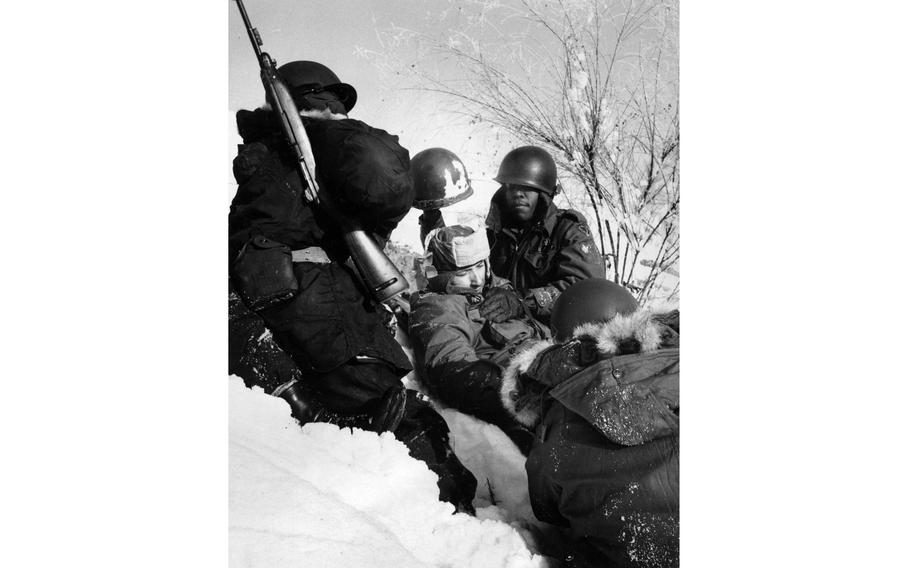 Medics practice treating a wounded soldier.