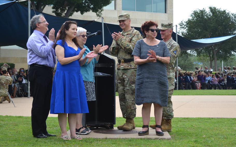 Members of the Cavazos family and the III Corps commanders clap as they watch the welcome sign unveiled outside of Fort Cavazos, Texas, during a ceremony Tuesday, May 9, 2023, to rename the base formerly known as Fort Hood in honor of Army Gen. Richard Cavazos. 
