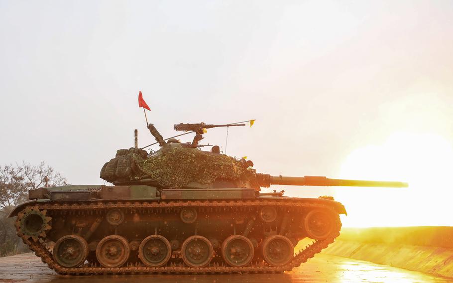 A tank fires off a shell into the distance.
