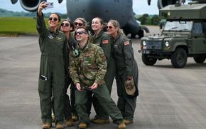 Air Force reservists of the 911th Aeromedical Evacuation Squadron take a group photo after an exercise at Leuchars Station, Scotland, in June 2024. A Rand Corp. report released Aug. 12, 2025, says the Pentagon should overhaul its duty status system for Guard members and reservists to reduce confusion and better standardize pay and benefits.