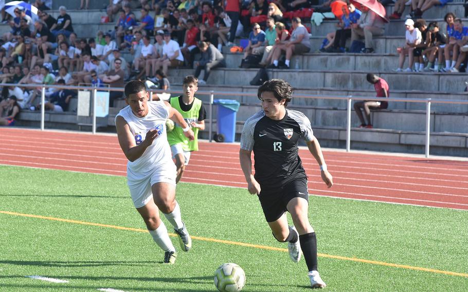 Stuttgart's Richard Youngs makes a run at the goal Wednesday, May 18, 2022, at the DODEA-Europe boys Division I semifinals while Wiesbaden's Nicholas Cardona tries to cut off his path at Ramstein Air Base, Germany.