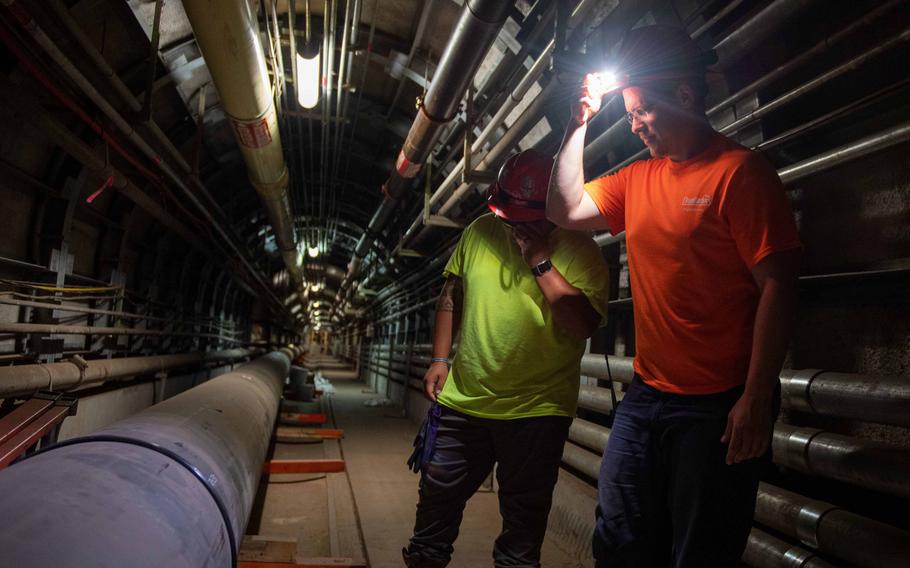 Navy contractors perform a routine inspection on a filtration system at the Red Hill well in Aiea, Hawaii, April 11, 2022.