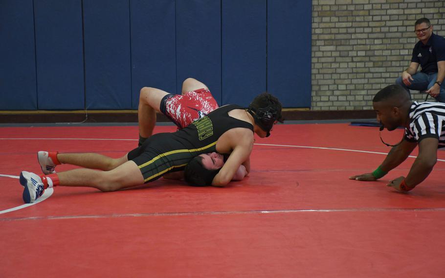 Alconbury's Mateo Moore puts his opponent in an awkward position before being awarded a pin at 150 pounds Saturday, Dec. 3, 2022 at RAF Lakenheath, England. 