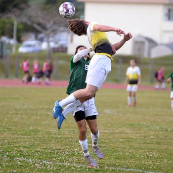 Kadena's Joey Puterbaugh heads the ball against Kubasaki's Matthew Yulee during Wednesday's Okinawa boys soccer match. The Panthers won 3-2.