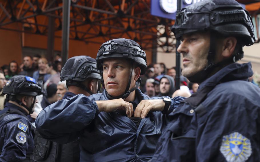 Kosovo police officers guard municipal building in the town of Zvecan, Kosovo, Friday, May 26, 2023. Small groups of ethnic Serbs in northern Kosovo on Friday clashed with police while trying to block the entrance of municipal buildings to prevent recently-elected officials from entering them, according to local media.