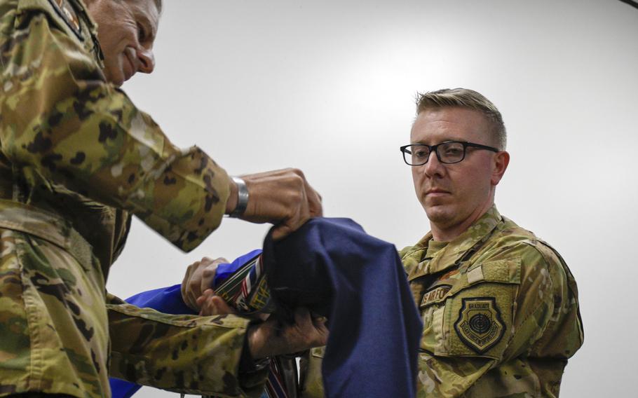 Lt. Col. Daniel A. Naske, commander of the 816th Expeditionary Airlift Squadron, cases the colors of the unit along with Maj. Gen. Corey J. Martin, commander, 18th Air Force, at a deactivation ceremony at Al Udeid Air Base, Sept. 30, 2022.