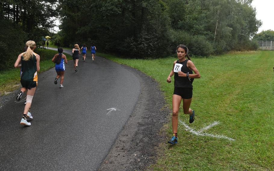 Stuttgart runner and race winner Lily Alder blazes past runners on her way to the finish of the girls 3.1-mile cross country race at Vilseck, Germany, Saturday, Sept. 10, 2022.  Alder finished the race with the time of 18:31.56. 