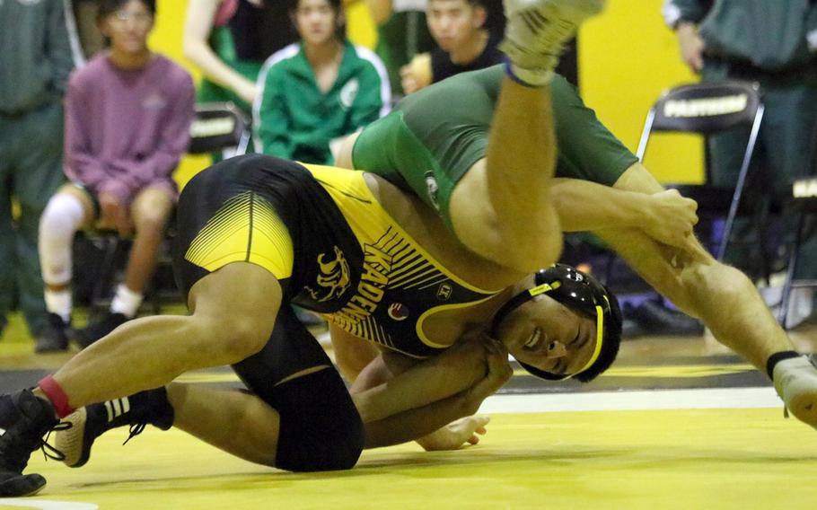 Kadena's Joseph Oh finds himself under Kubasaki's Max Lundberg at 148 pounds during Wednesday's Okinawa wrestling dual meet. Lundberg pinned Oh in 52 seconds and the Dragons won the meet 39-26.