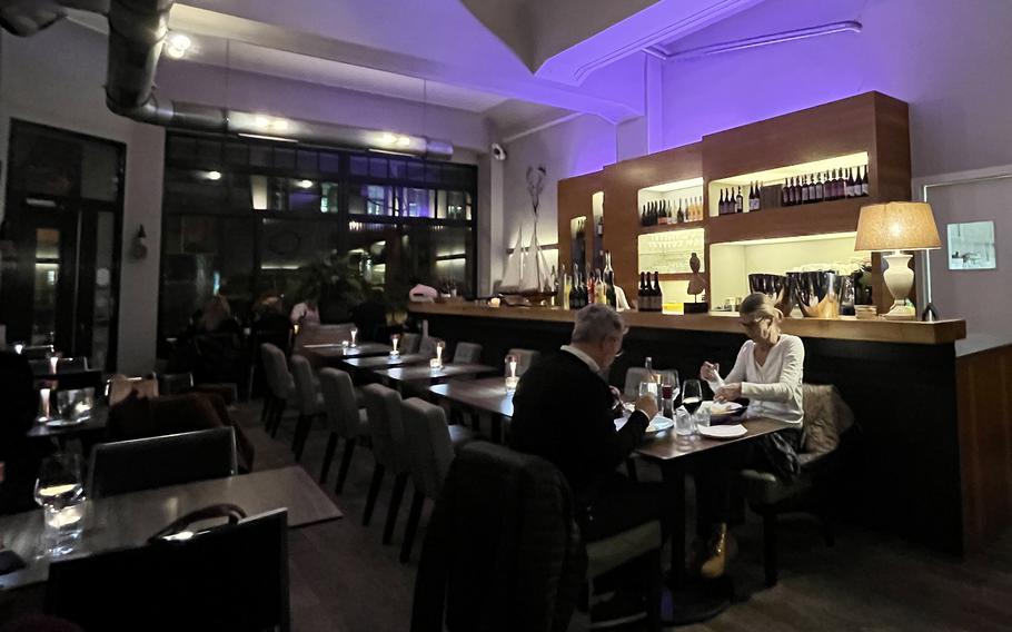 The interior of Mathilda, a restaurant and wine bar in downtown Wiesbaden, Germany. Tall windows, soft lighting and the glow of candles give the place a relaxing atmosphere.