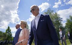 President Joe Biden, right, walks with European Commission President Ursula von der Leyen, center, and European Council President Charles Michel, left, as they head to a family photo with the G7 leaders at the G7 Summit in Elmau, Germany, Sunday, June 26, 2022.
