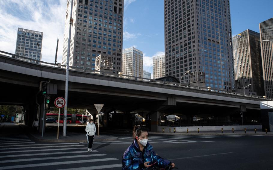 A near-deserted road in Beijing, on Nov. 26, 2022. China's daily coronavirus infections broke through 30,000 for the first time ever, as officials struggle to contain outbreaks that have triggered a growing number of restrictions across the country's most important cities.