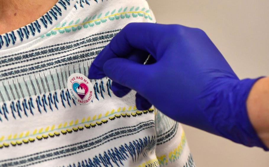 A patient wears a sticker after receiving the COVID-19 vaccine at the Royal Health & Wellbeing Centre in Oldham, U.K.