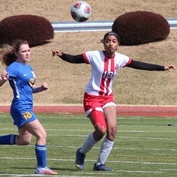 Yokota’s Hailey Riddels and Nile C. Kinnick’s Alyssa Staples chase the ball during Friday’s Red Devils’ 4-1 victory in the Trojan War Cup.