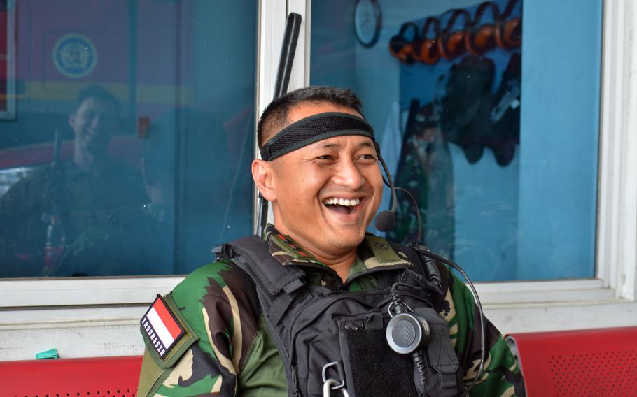 Indonesian air force Lt. Col. Tri Wicaxsono jokes with U.S. Marines during Super Garuda Shield training in Palembang, Indonesia, Monday, Aug. 8, 2022.