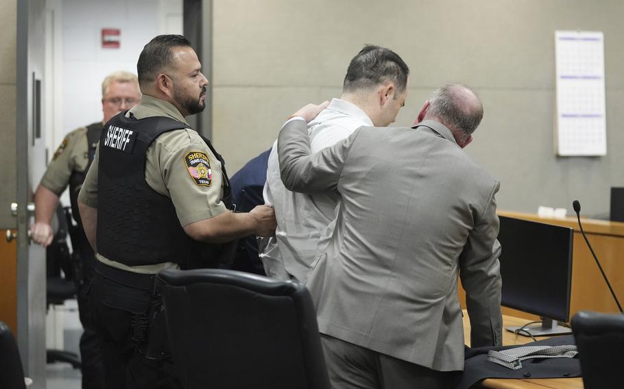 U.S. Army Sgt. Daniel Perry is comforted by his attorney Doug O'Connell after he was convicted of murder in the killing of Garrett Foster, an armed protester in 2020 during nationwide protests against police violence and racial injustice, Friday, April 7, 2023, at the Blackwell-Thurman Criminal Justice Center in Austin, Texas. Perry, who faces life in prison, now awaits sentencing. 