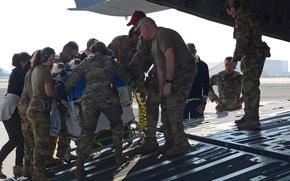 Service members from the156th Airlift Squadron, North Carolina Air National Guard, and Brooke Army Medical Center help a premature baby suffering from a low heart rate and oxygen saturation. The baby was evacuated from Kuwait to Germany on a C-17 Globemaster III aircraft on Dec. 25, 2022.




