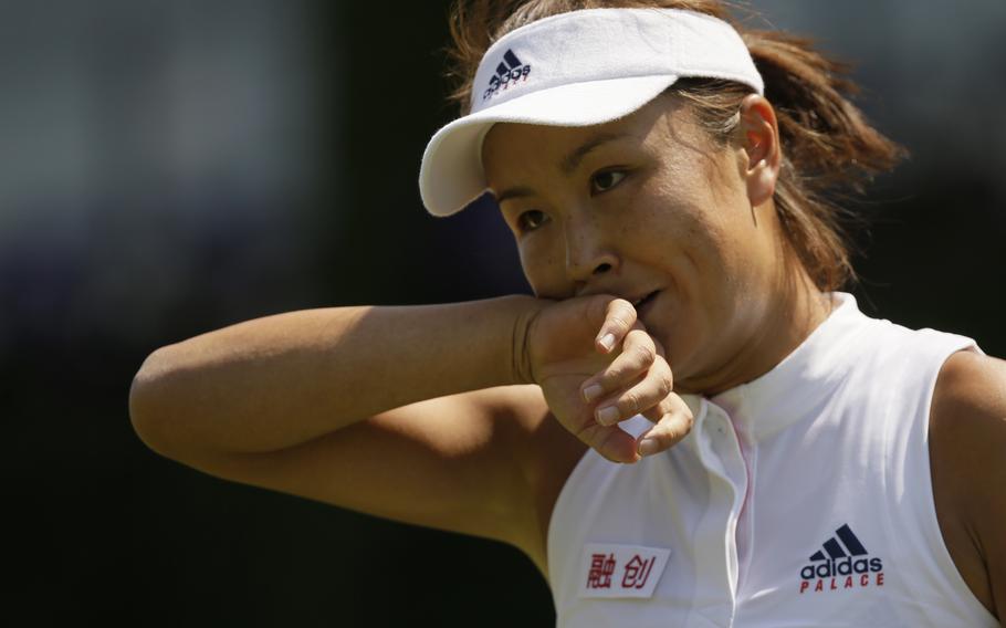 Peng Shuai of China wipes her face during the women’s singles match against Samantha Stosur of Australia on the second day at the Wimbledon Tennis Championships in London, on July 3, 2018. The editor of a Communist Party newspaper posted a video online that he said showed missing tennis star Peng Shuai watching a match Sunday, Nov. 21, 2021 as the ruling party tried to quell fears abroad while suppressing information in China about Peng after she accused a senior leader of sexual assault.